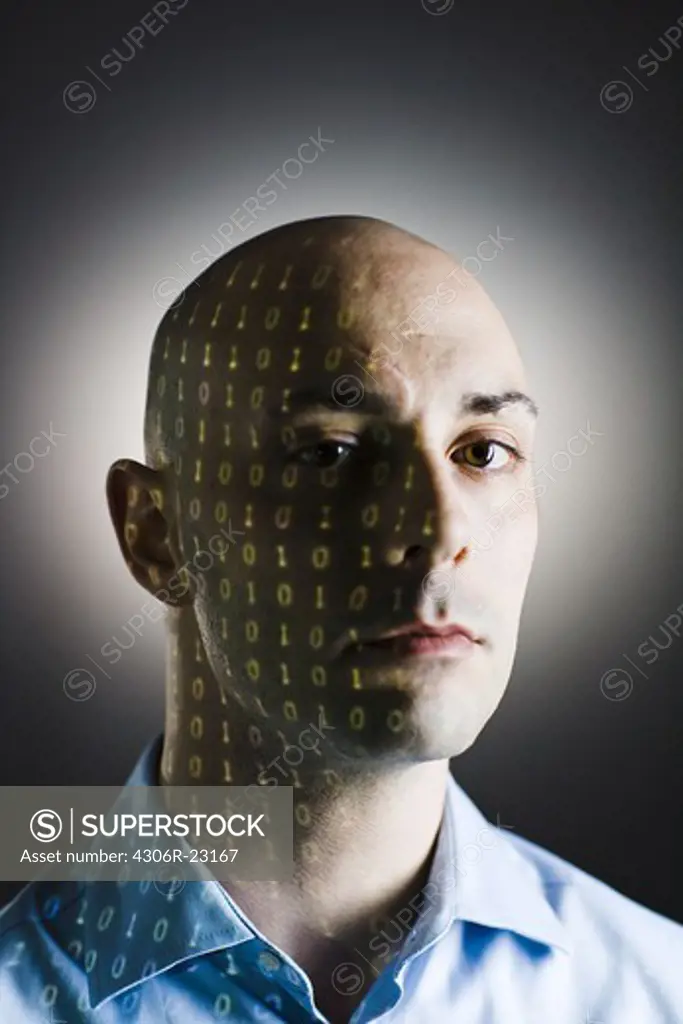 Close-up of a man with digital numbers reflected on his face.