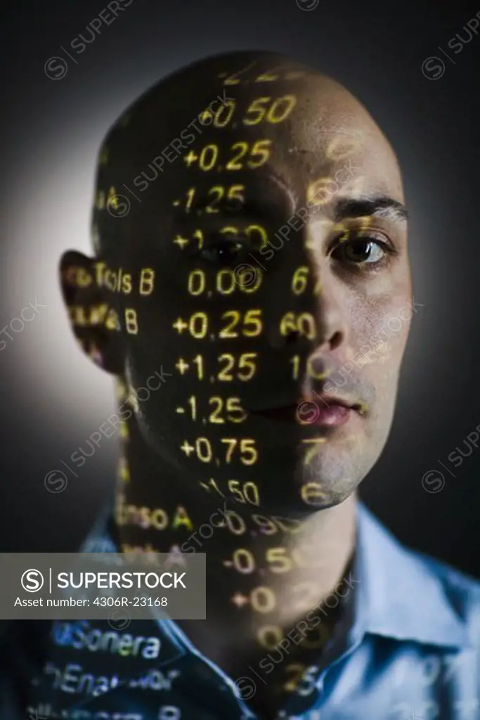 A man with the stock-exchange quotation reflected on his face.