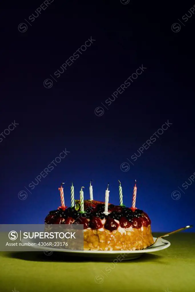 Fruit cake with blown out candles.