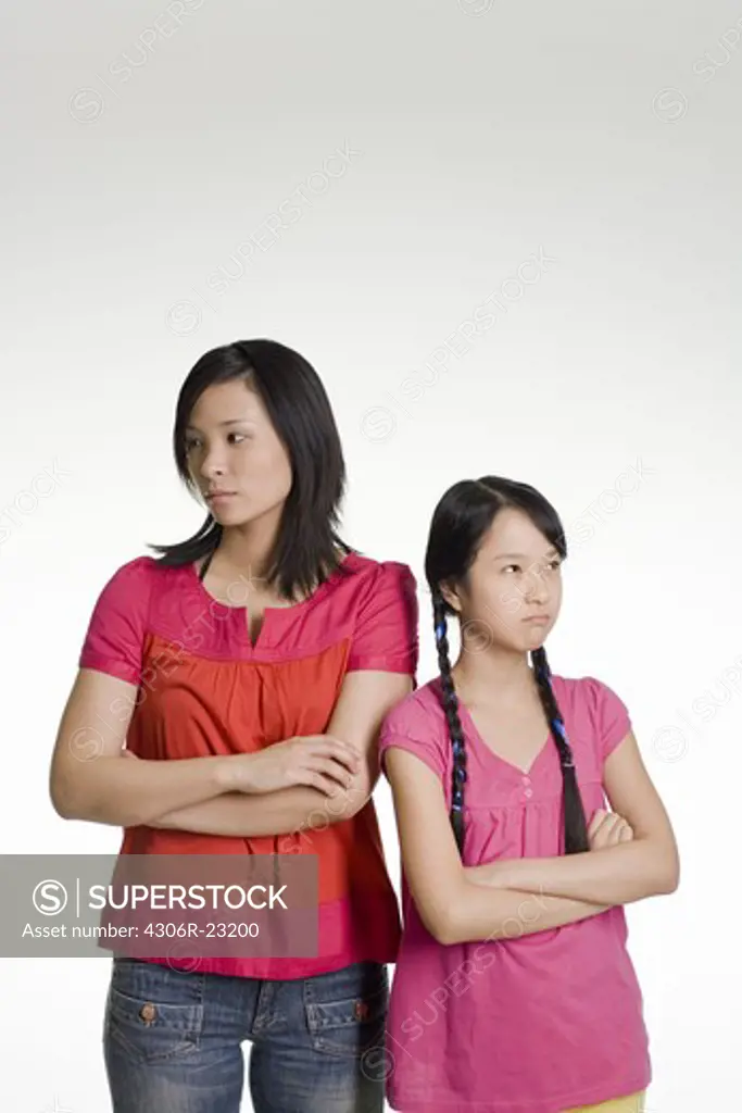 Woman and girl standing side by side.