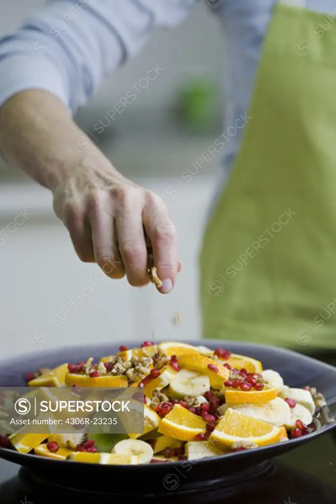 Woman making a fruit salad, Sweden.