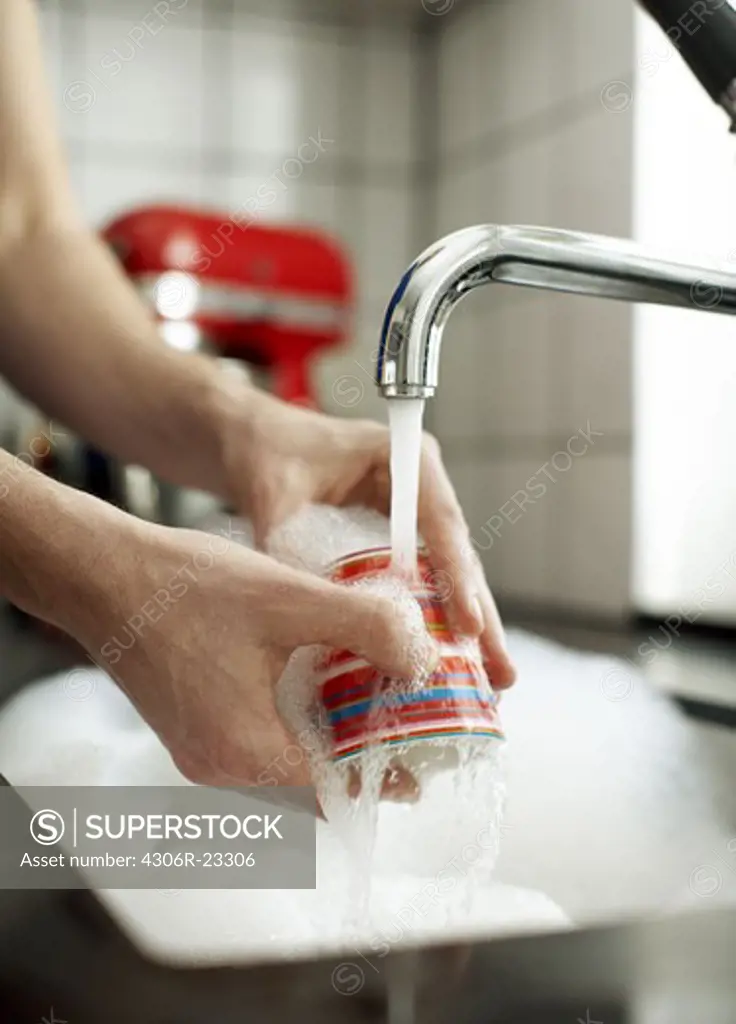 Close-up of woman washing dishes