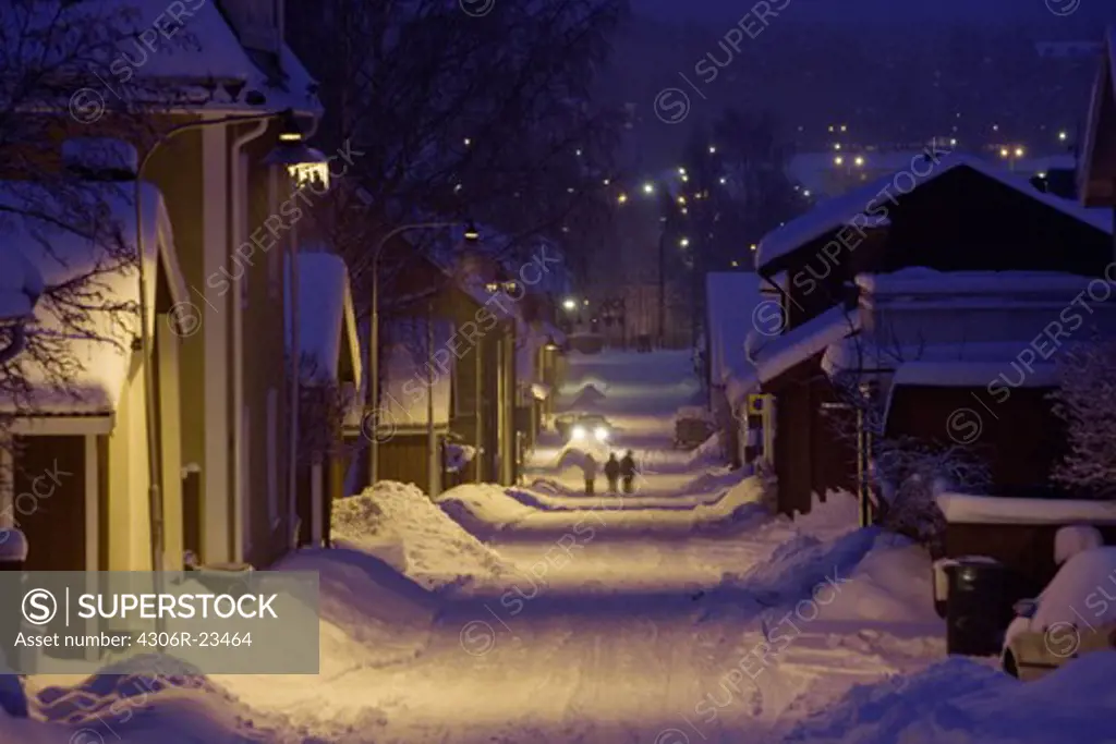 Snow covered buildings and street at dawn