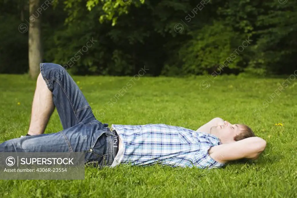 A relaxed man on a lawn, Sweden.