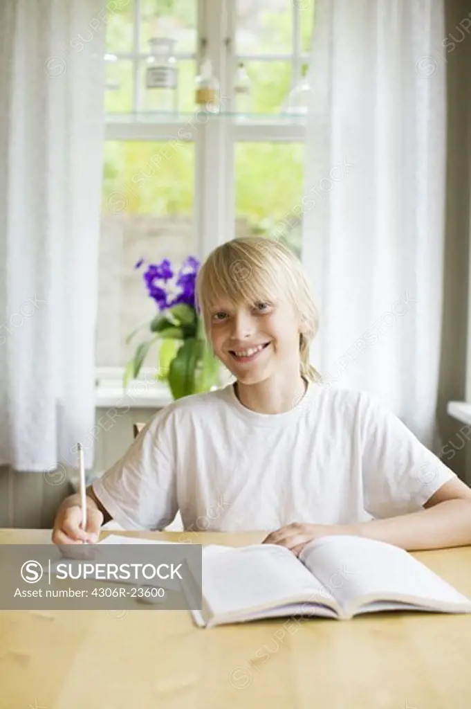 A blond boy doing his homework, Sweden.