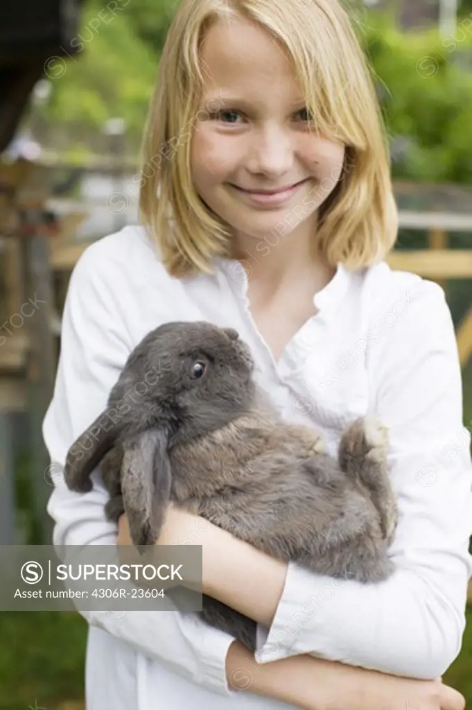 Girl holding a rabbit, Sweden.