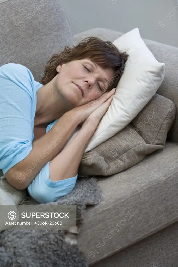 Mature woman sleeping on sofa