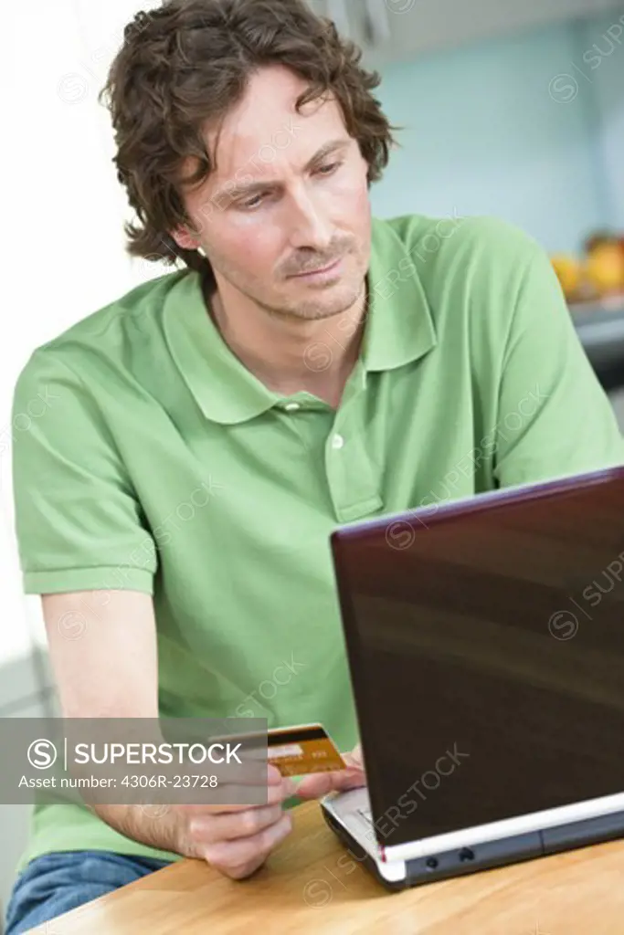 Mid-adult man  online shopping