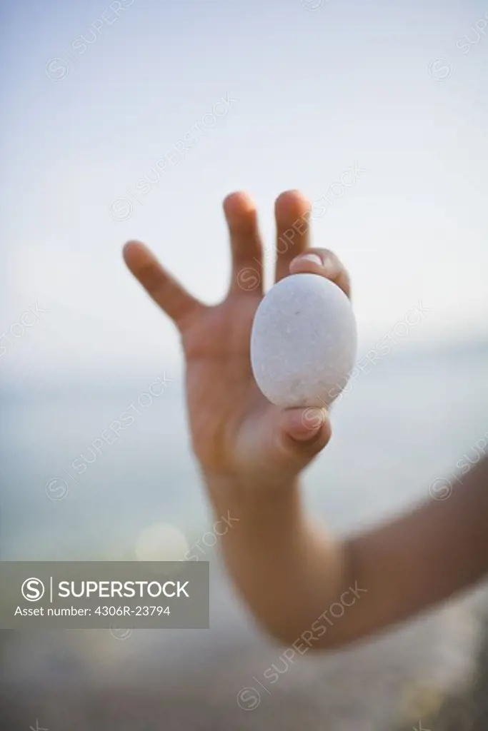 Child holding pebble