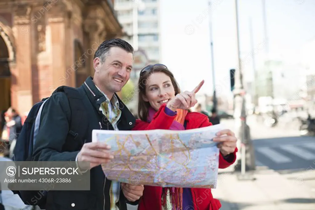 Couple with map sightseeing in city
