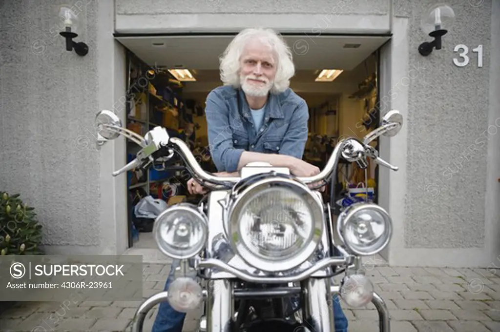 Portrait of senior man on vintage motorbike
