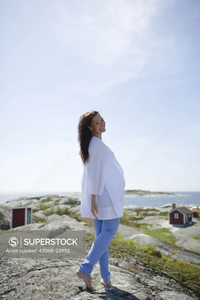 Woman standing on rock, smiling
