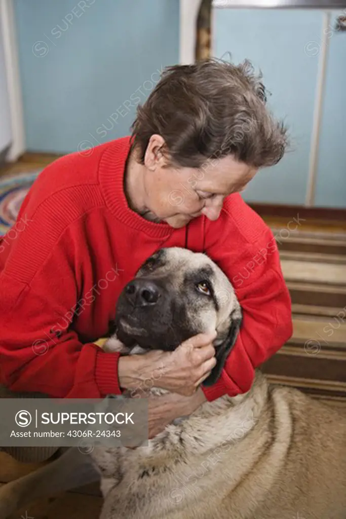 Senior woman hugging dog