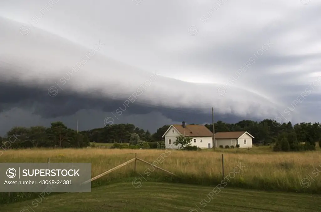 Storm clouds over cottage house