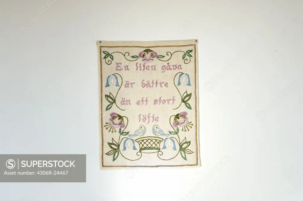 Embroidered message on a wall hanging, Sweden.