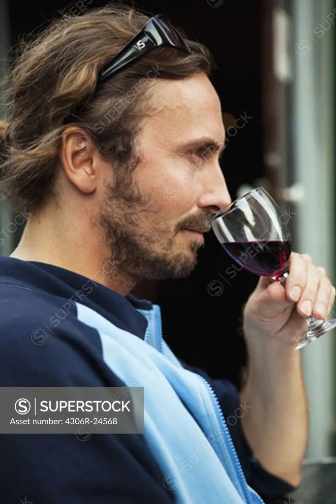 Mid adult man drinking red wine