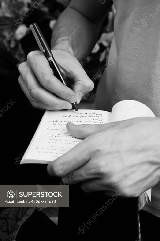 Man writing on diary