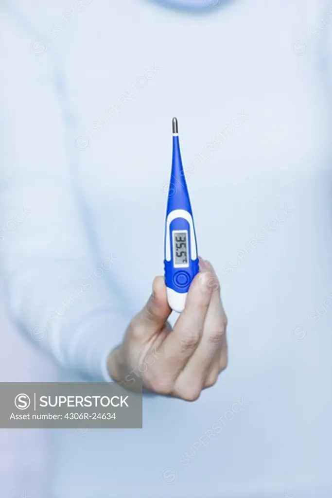 Woman holding thermometer