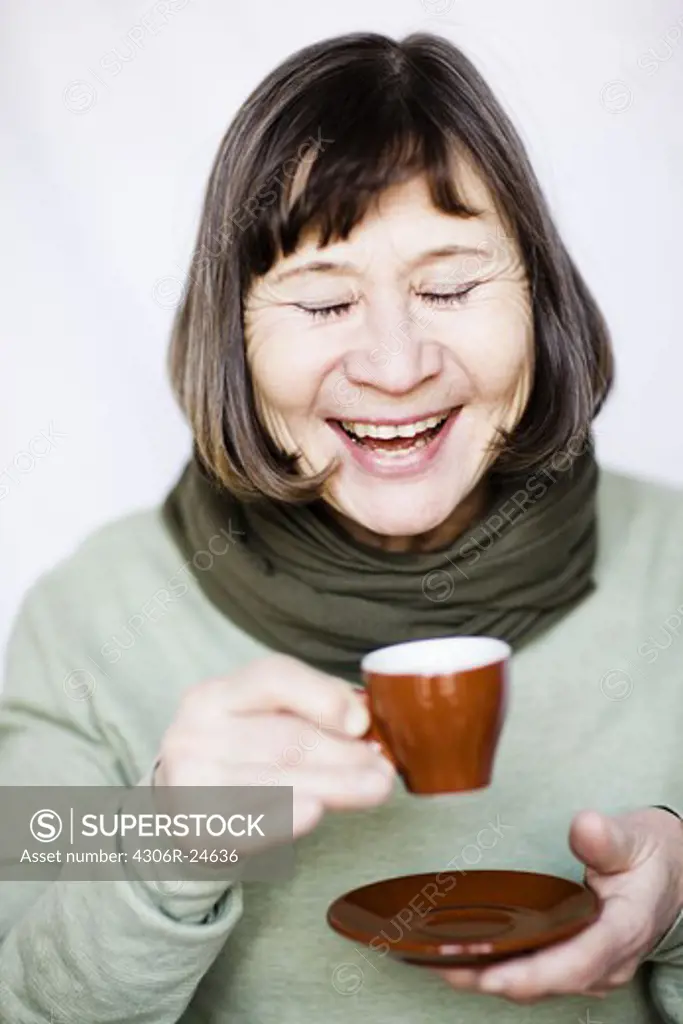 Smiling woman drinking coffee