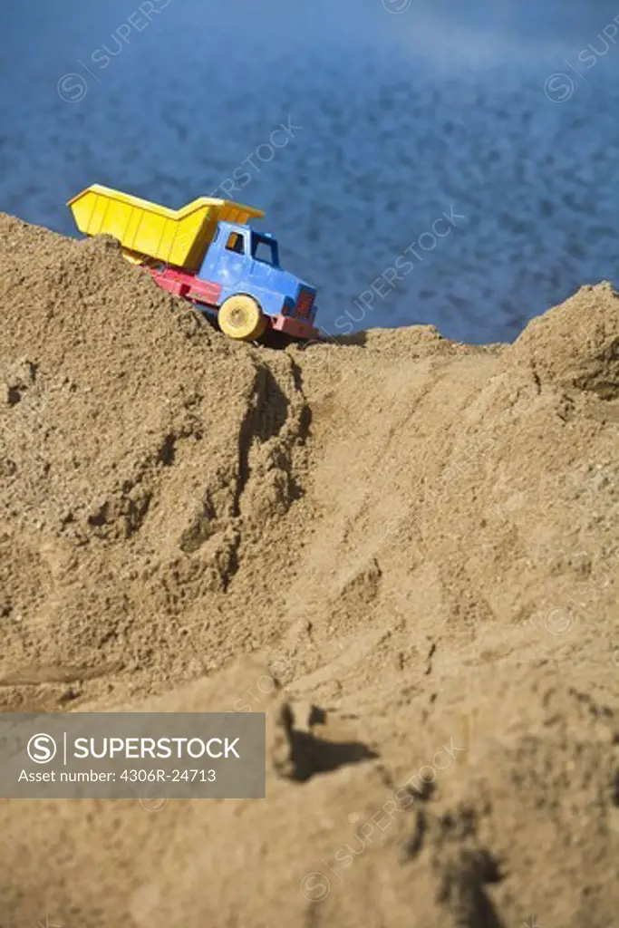 Toy truck on top of heap of sand