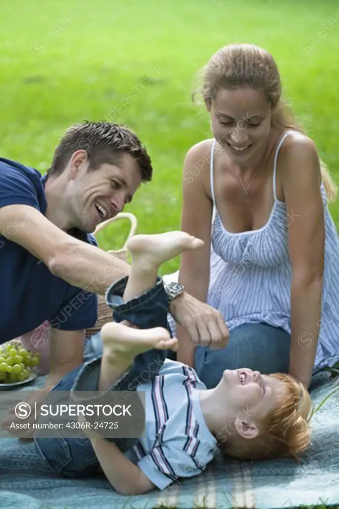 Mid adult parents playing with son