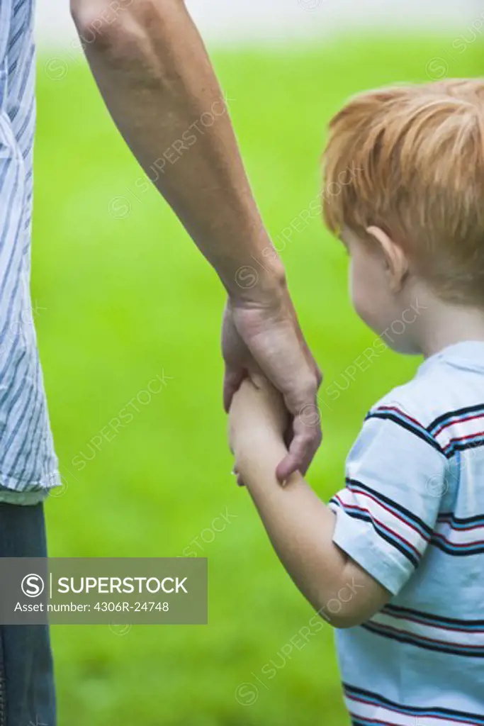 Father holding sons hand