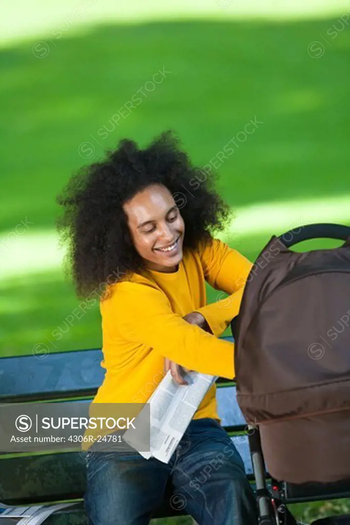 Smiling young man with baby carriage