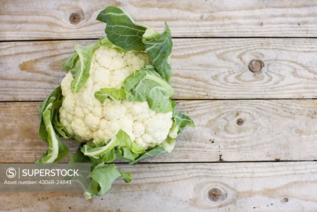 Overhead view of cauliflower on wooden table