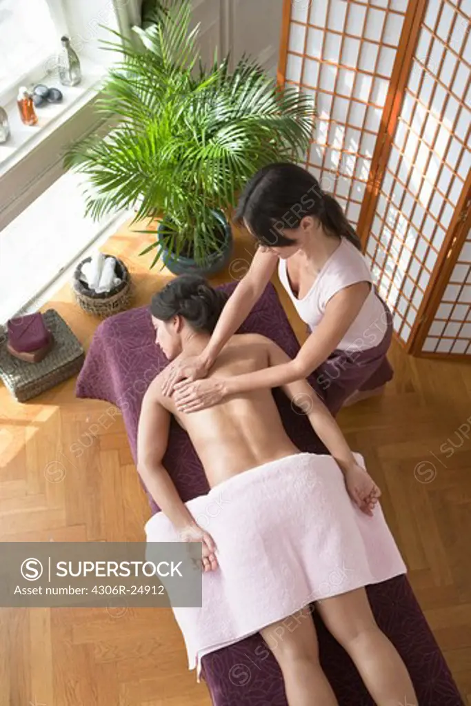 Woman having back massage at health spa