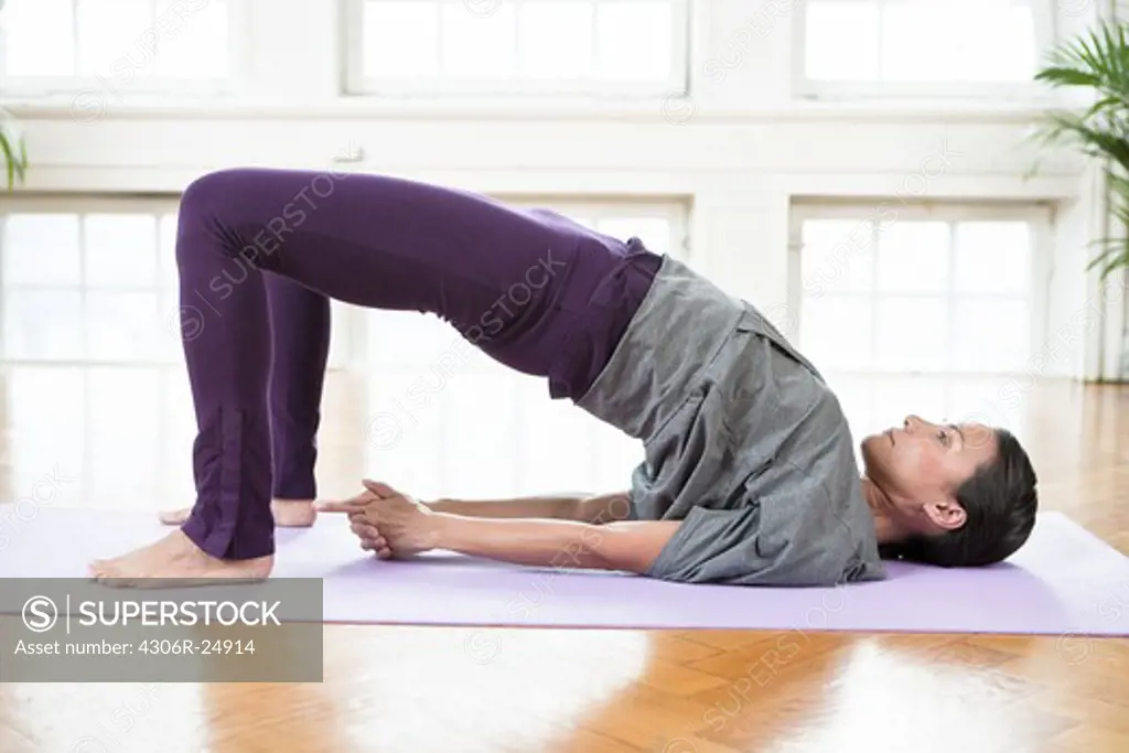 Woman doing yoga in gym