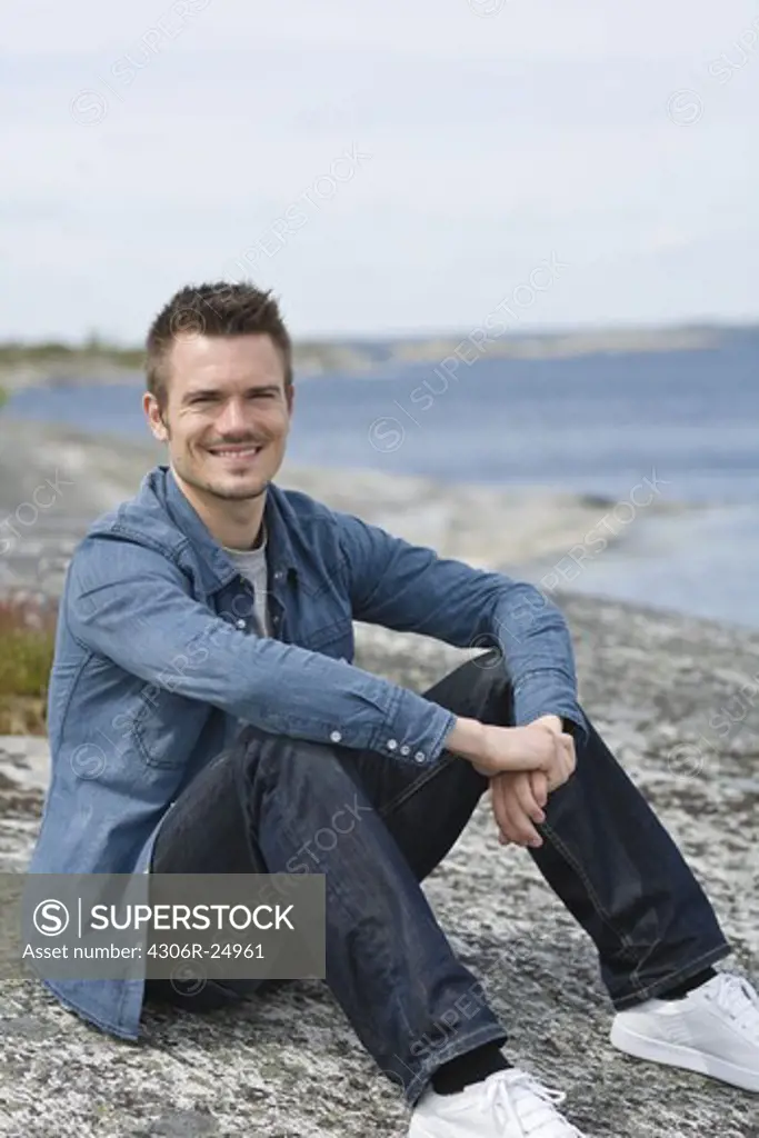 Portrait of man sitting on beach