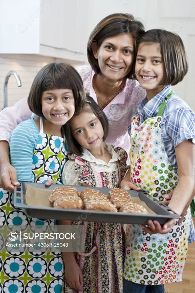 Portrait of mother with three daughters with freshly made rolls