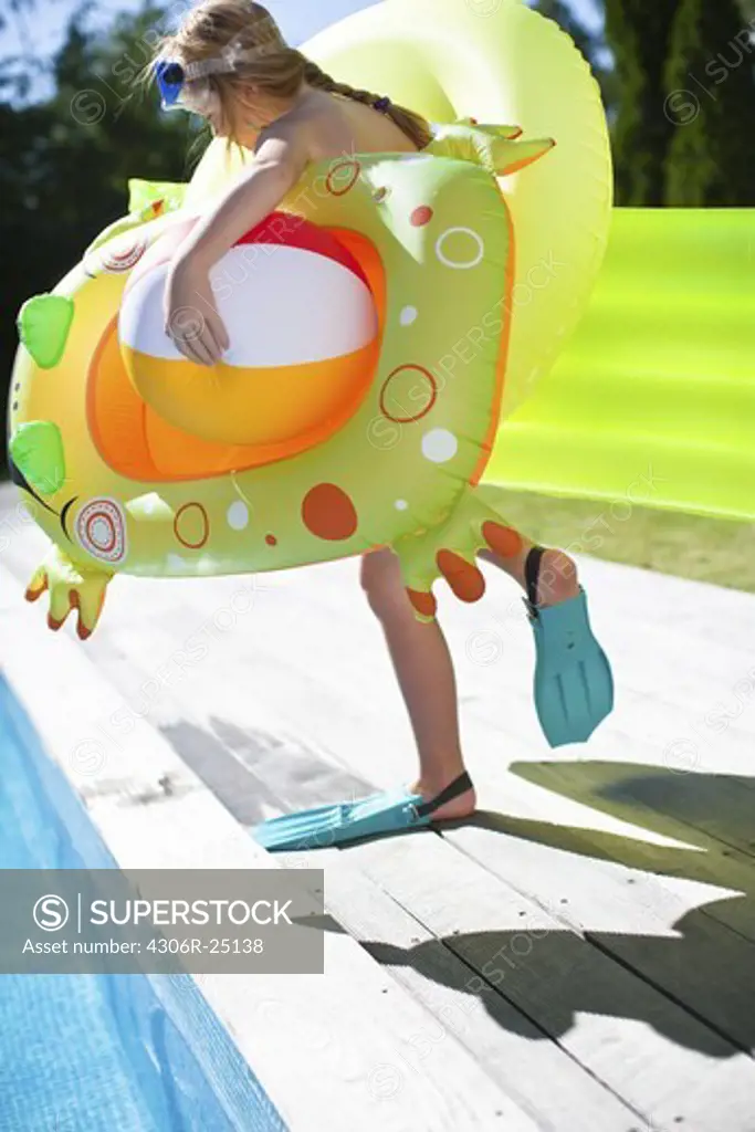Girl jumping into swimming pool
