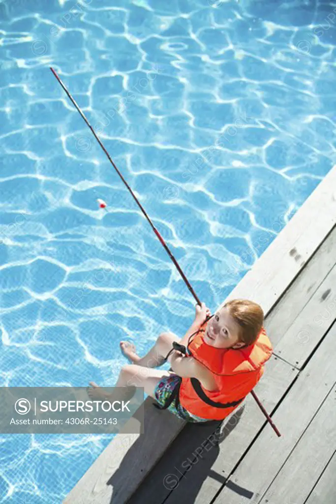 Girl fishing in swimming pool