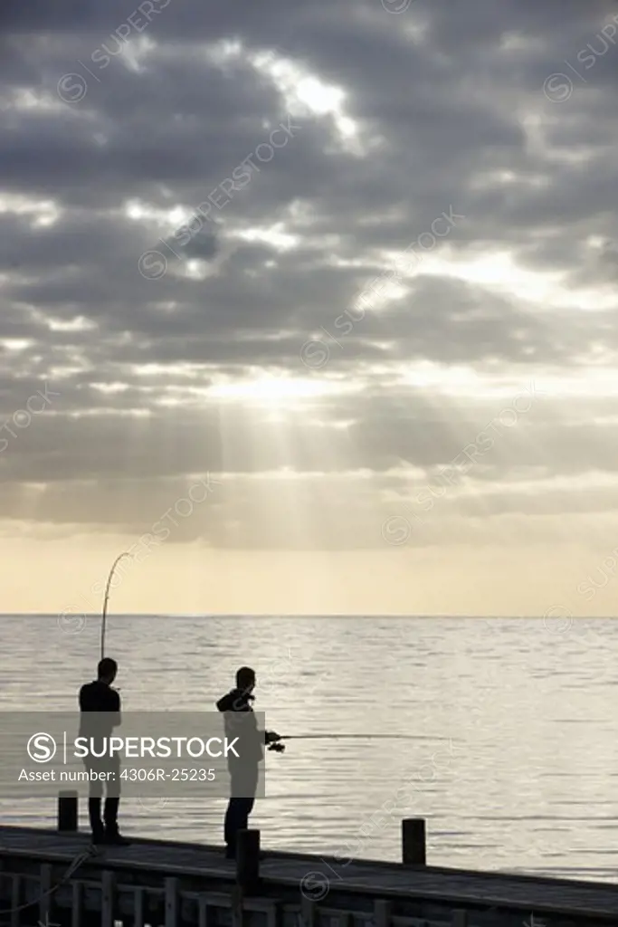 Two men fishing from jetty