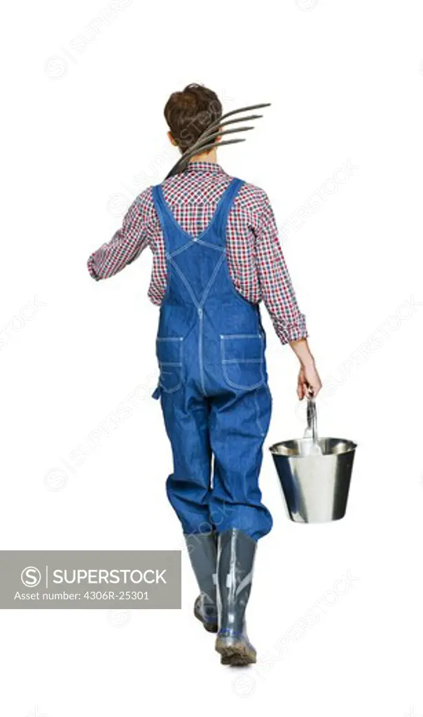 Studio shot of farmer with pitchfork and bucket