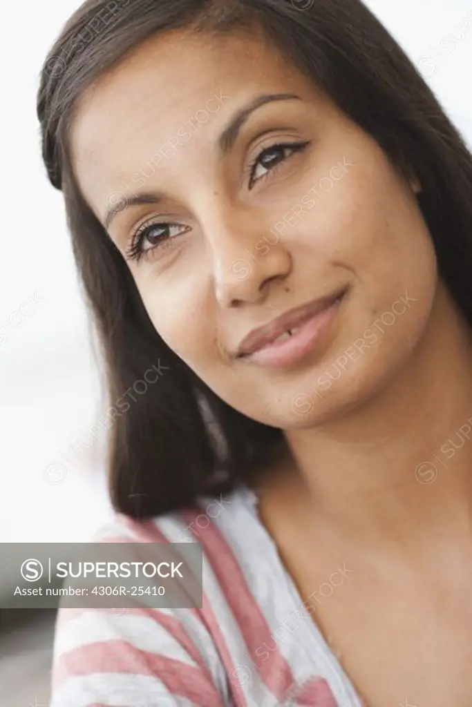 Pensive woman smiling outdoors