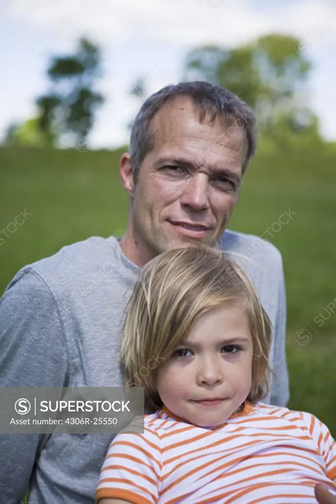 Portrait of father with son looking at camera
