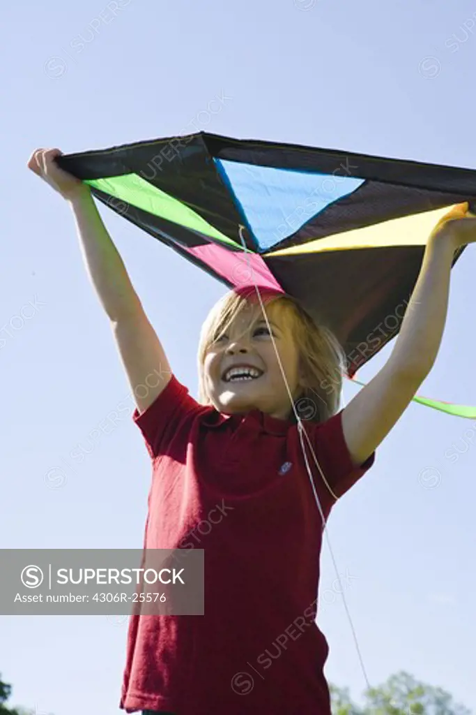 Portrait of boy  holding kite