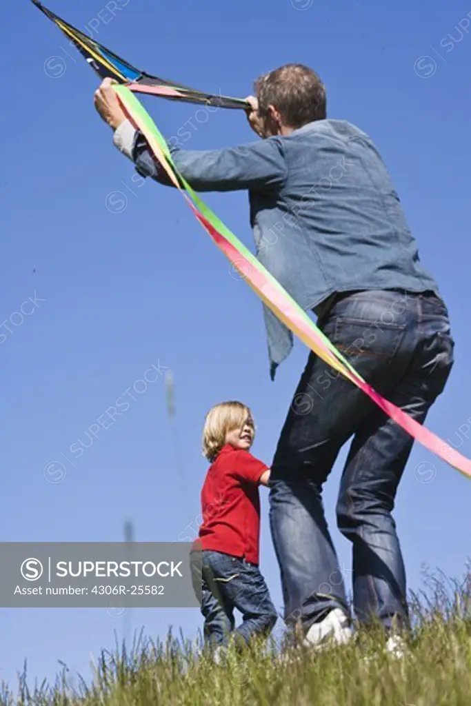 Father and son  flying kite