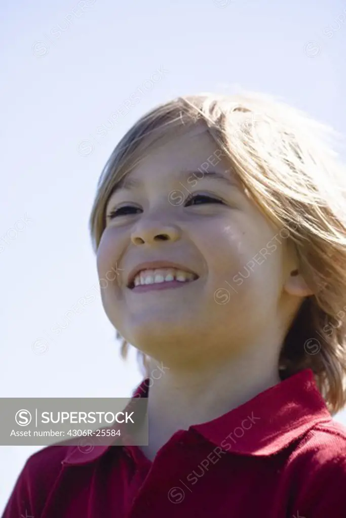 Portrait of smiling boy in bright sunlight