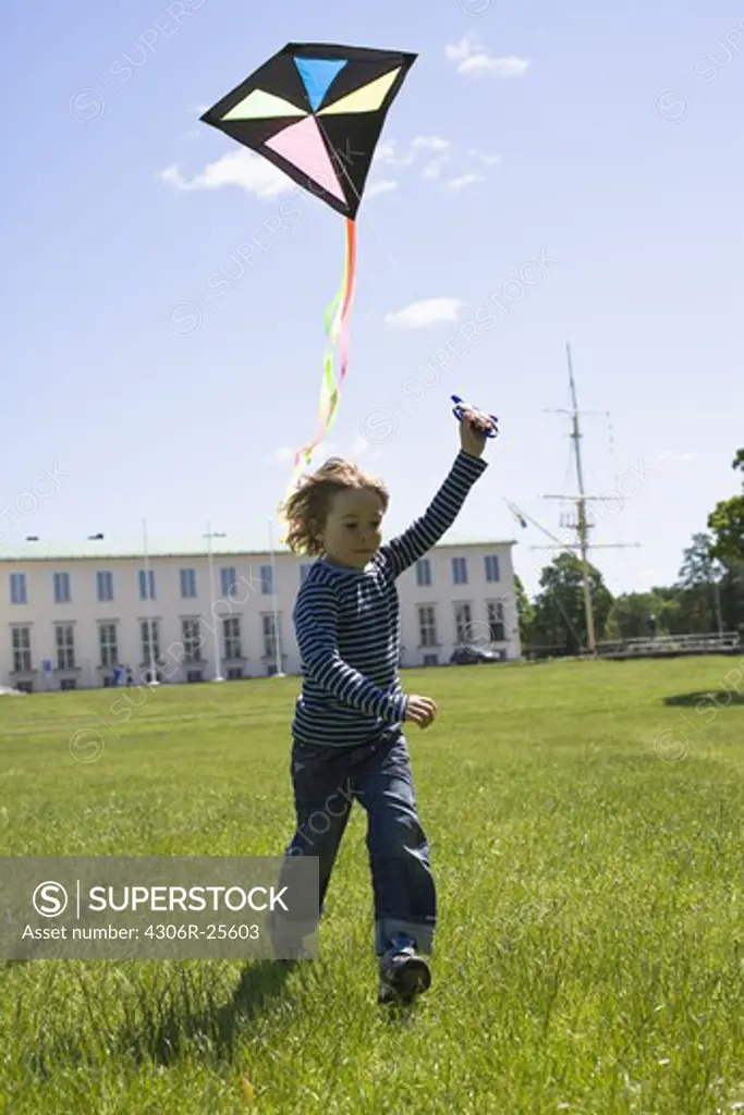 Boy flying kite in bright sunlight