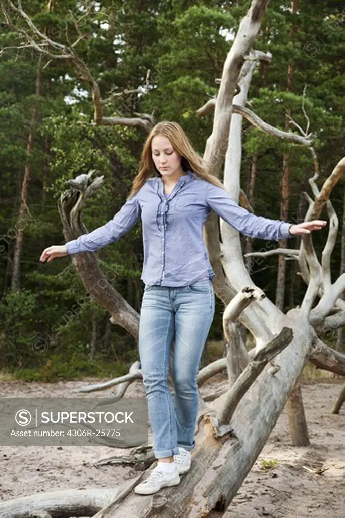 Woman balancing on fallen tree