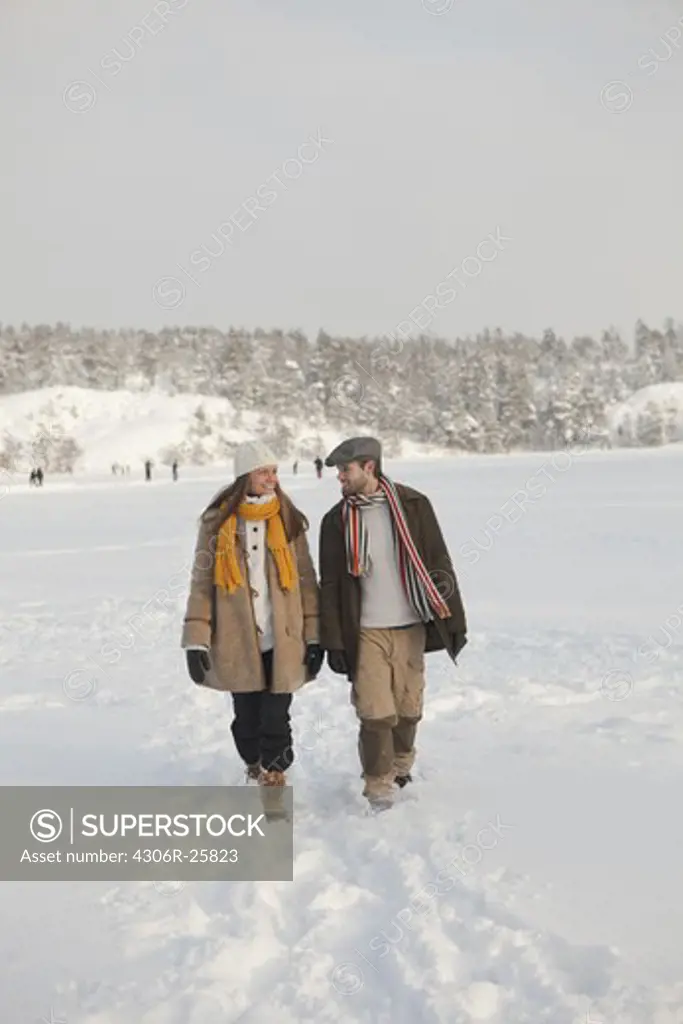 Mid adult couple holding hands and walking