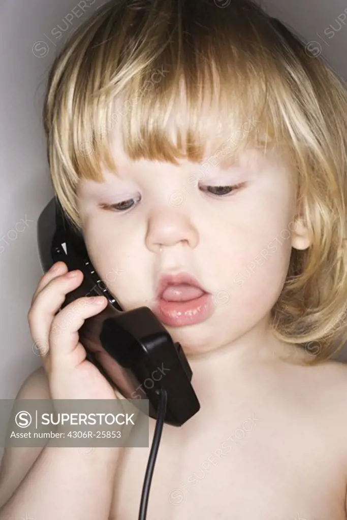 Boy using telephone