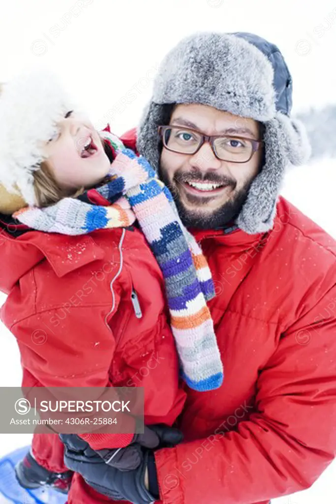 Father and daughter in winter clothing