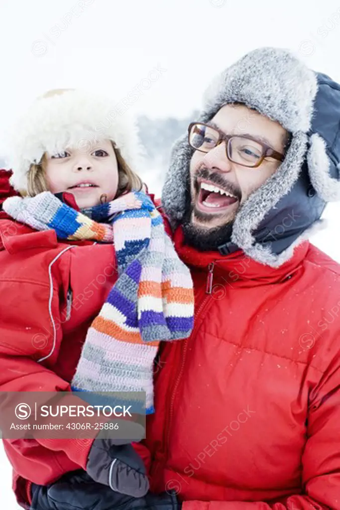 Father and daughter in winter clothing