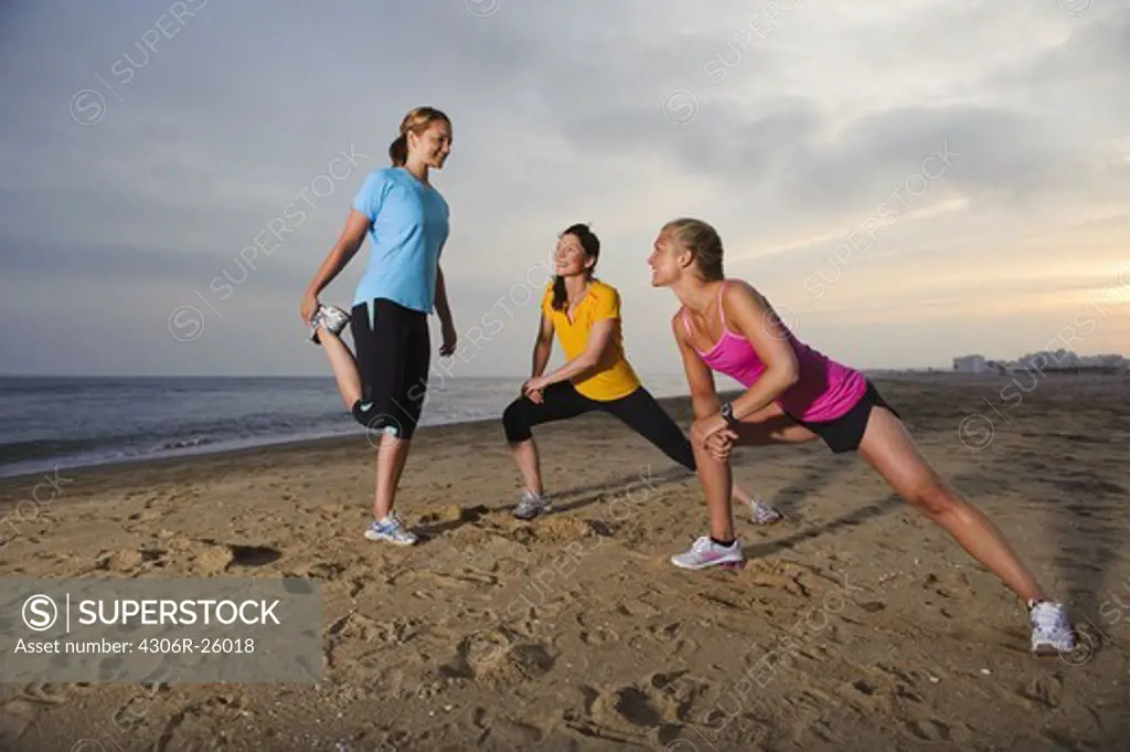 Women exercising on beach