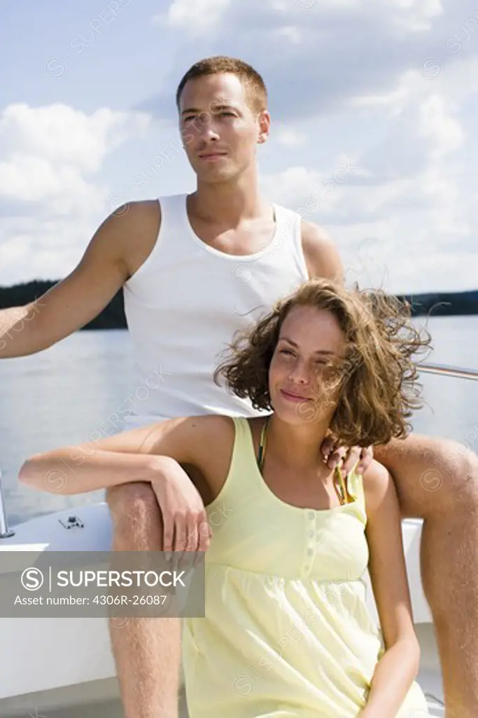 Couple relaxing in boat on sea