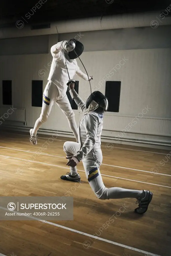 Two fencers in sports hall